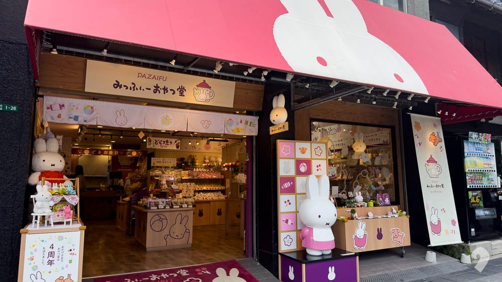 Character goods souvenir shop featuring Miffy themed items with a pink awning